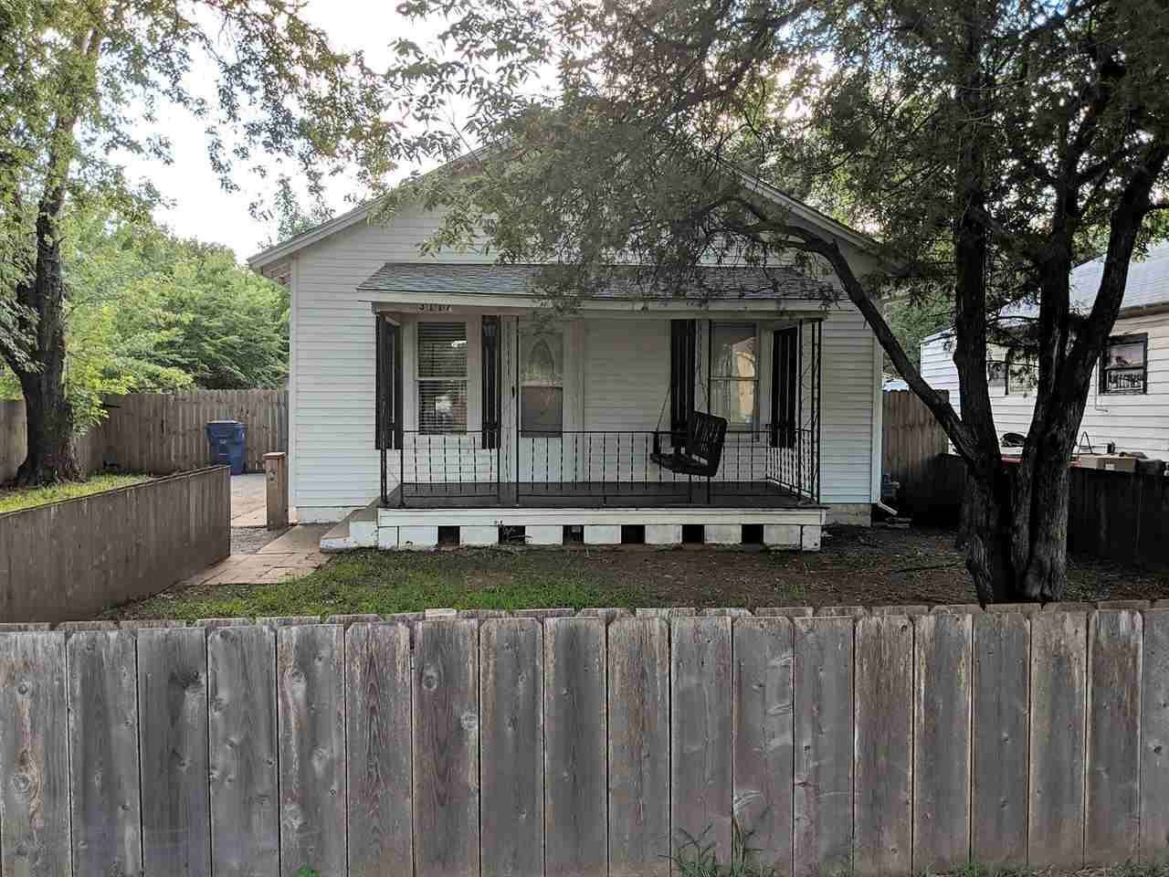 Cute Little 2 Bedroom Bungalow with Fenced yard, Over-sized 2 Car Garage, Unfinished Basement, Covered Front Porch w/ Swing :) Hardwood floors, new Storm Door, Newer Plumbing and More :)